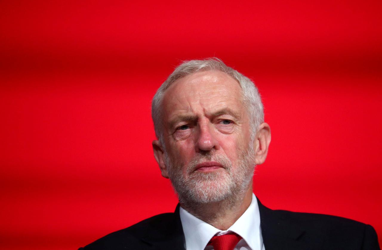 FILE PHOTO: Britain&rsquo;s Labour Party Leader Jeremy Corbyn sits on stage at the annual Labour Party Conference in Liverpool