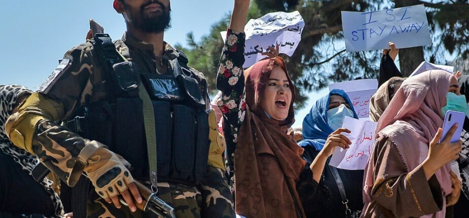 Des Afghanes manifestent contre l'ingérence du Pakistan, sous l'oeil d'un combattant taliban, à Kaboul le 7 septembre 2021