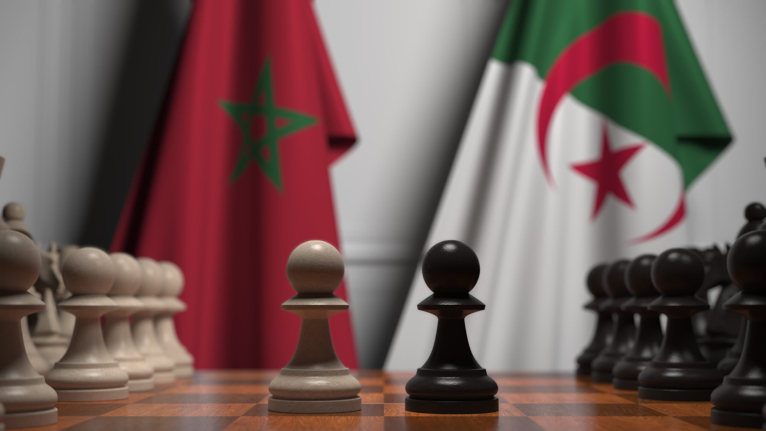 Flags,Of,Algeria,And,Morocco,Behind,Pawns,On,The,Chessboard.