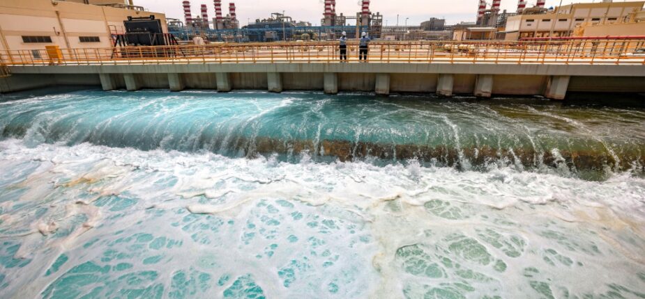 Deux employés de l'usine de dessalement de Ras al-Khaïr discutent le 30 mars 2023 dans cette installation située dans l'est de l'Arabie saoudite